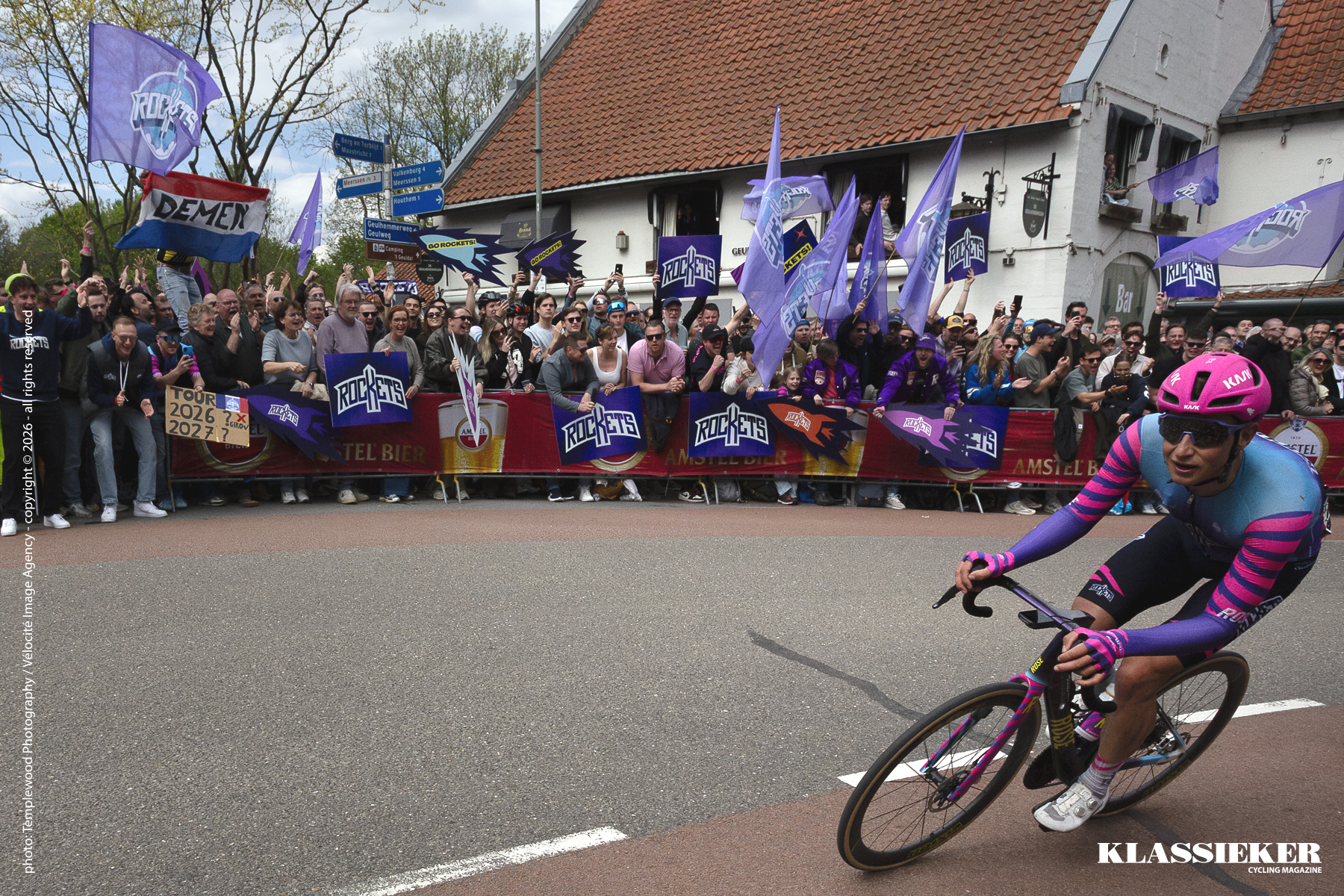 Amstel Gold Race 2026 - Abram Stockman passes enthusiastic Unibet Rose Rockets fans waving flags and holding signs supporting the team