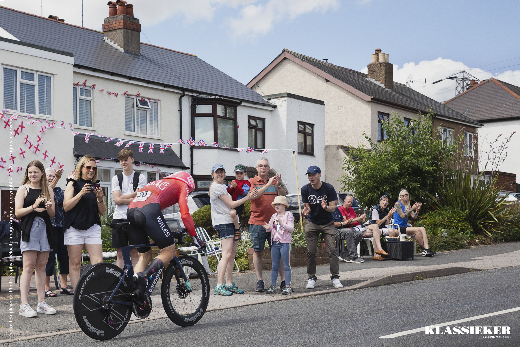 Birmingham 2022 - Owain Doull rides past spectators outside a house covered in bunting