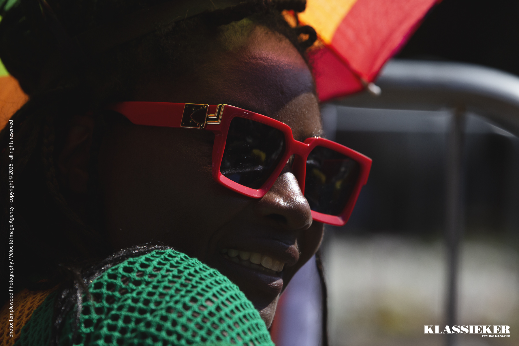 Birmingham 2022 - A Ghanaian fan dressed in the colours of the country looks over her shoulder and smiles