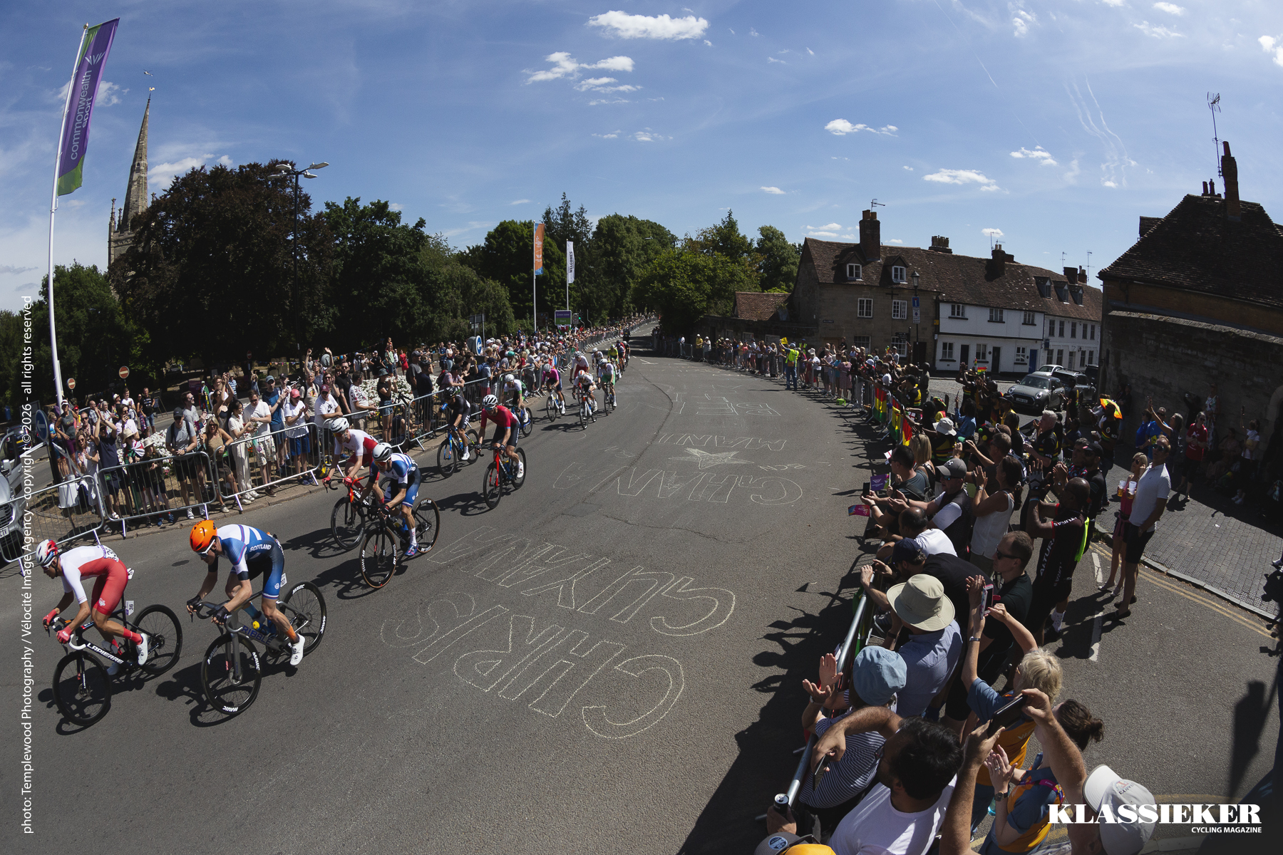 Birmingham 2022 - Riders pass through the crowd lined streets of Warwick