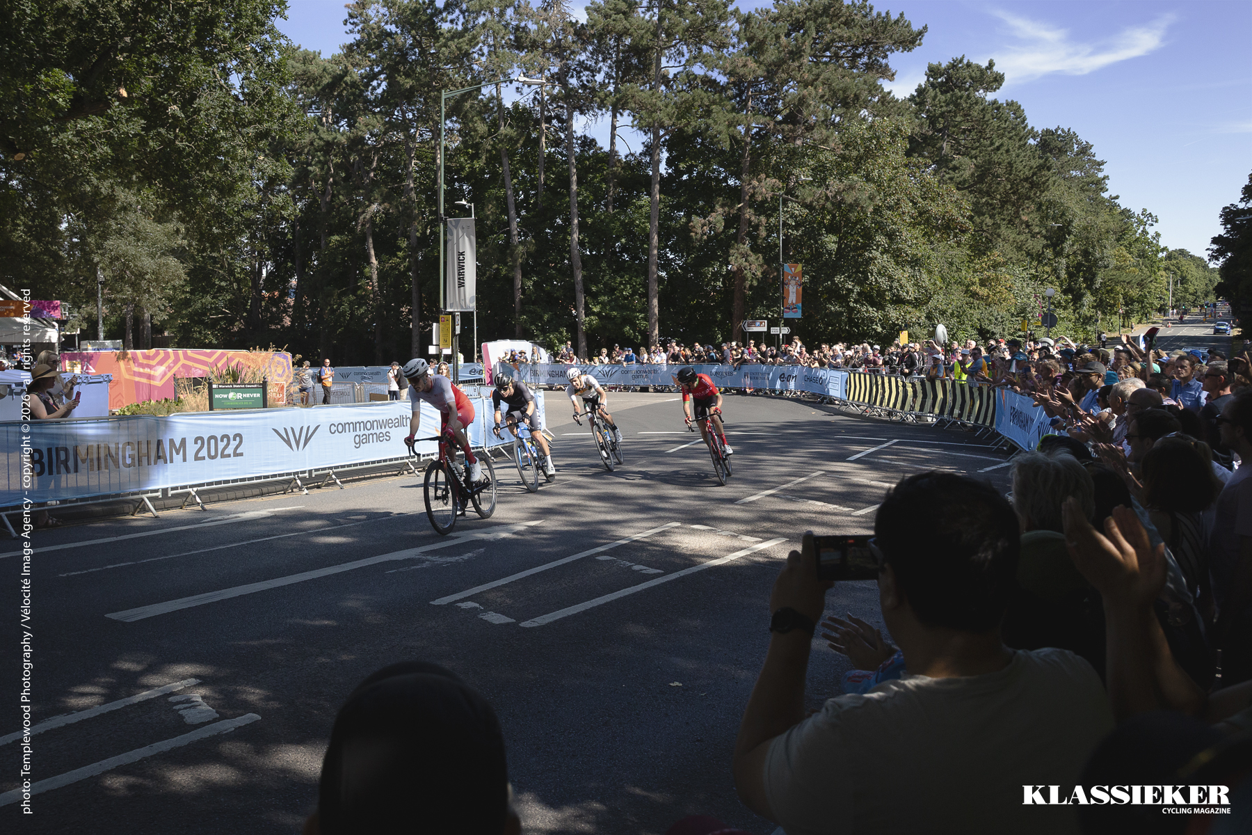 Birmingham 2022 - Riders round a corner as large crowds watch on