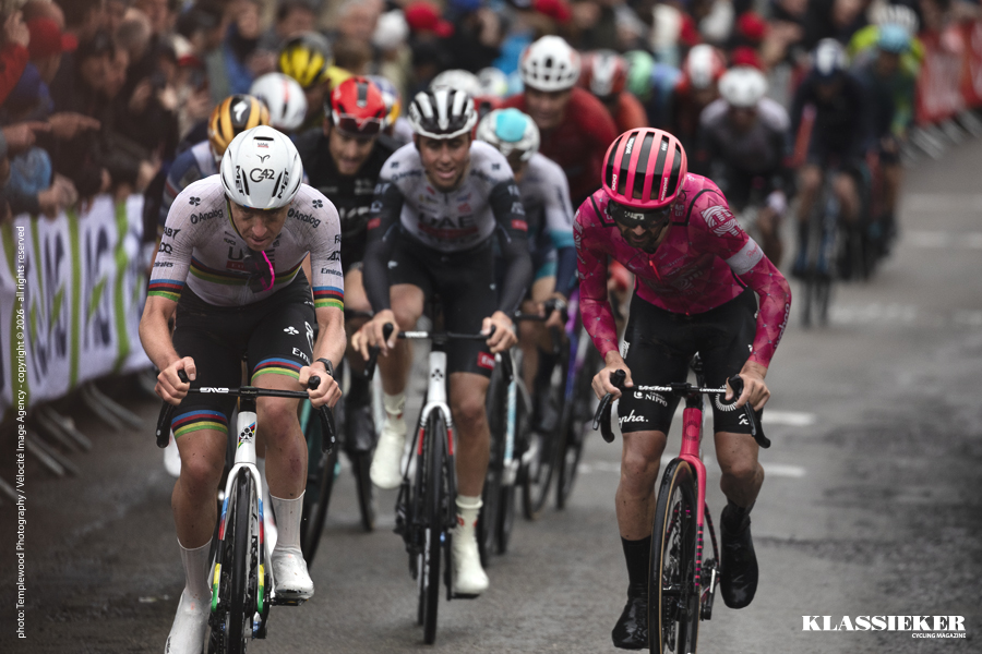 Tadej Pogačar puts his sunglasses in his mouth as he launches his winning attack during La Flèche Wallonne 2025. The dismal weather increasing the riders effort